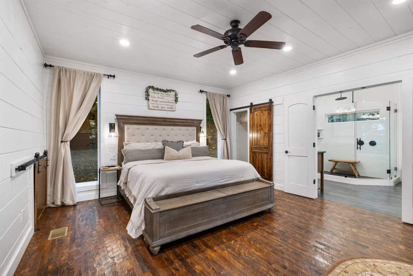 Primary suite with a king bed and barn doors.